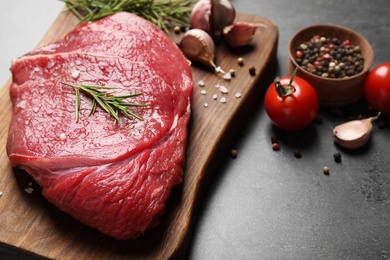 Photo of Fresh raw meat on grey table, closeup