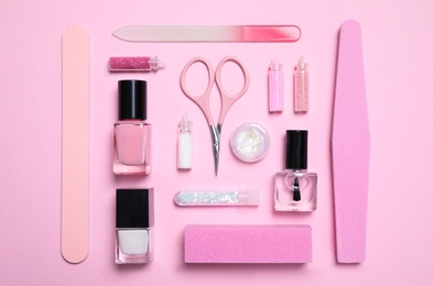 Photo of Flat lay composition with nail care products on pink background