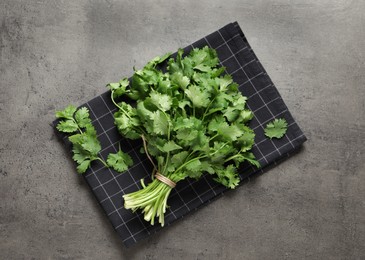 Bunch of fresh aromatic cilantro on grey table, top view