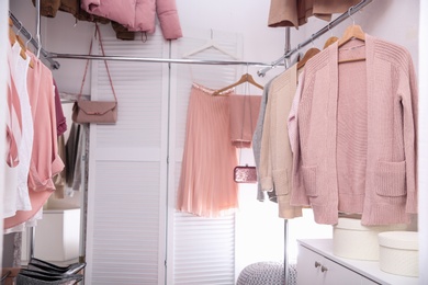 Modern dressing room with different stylish clothes and accessories