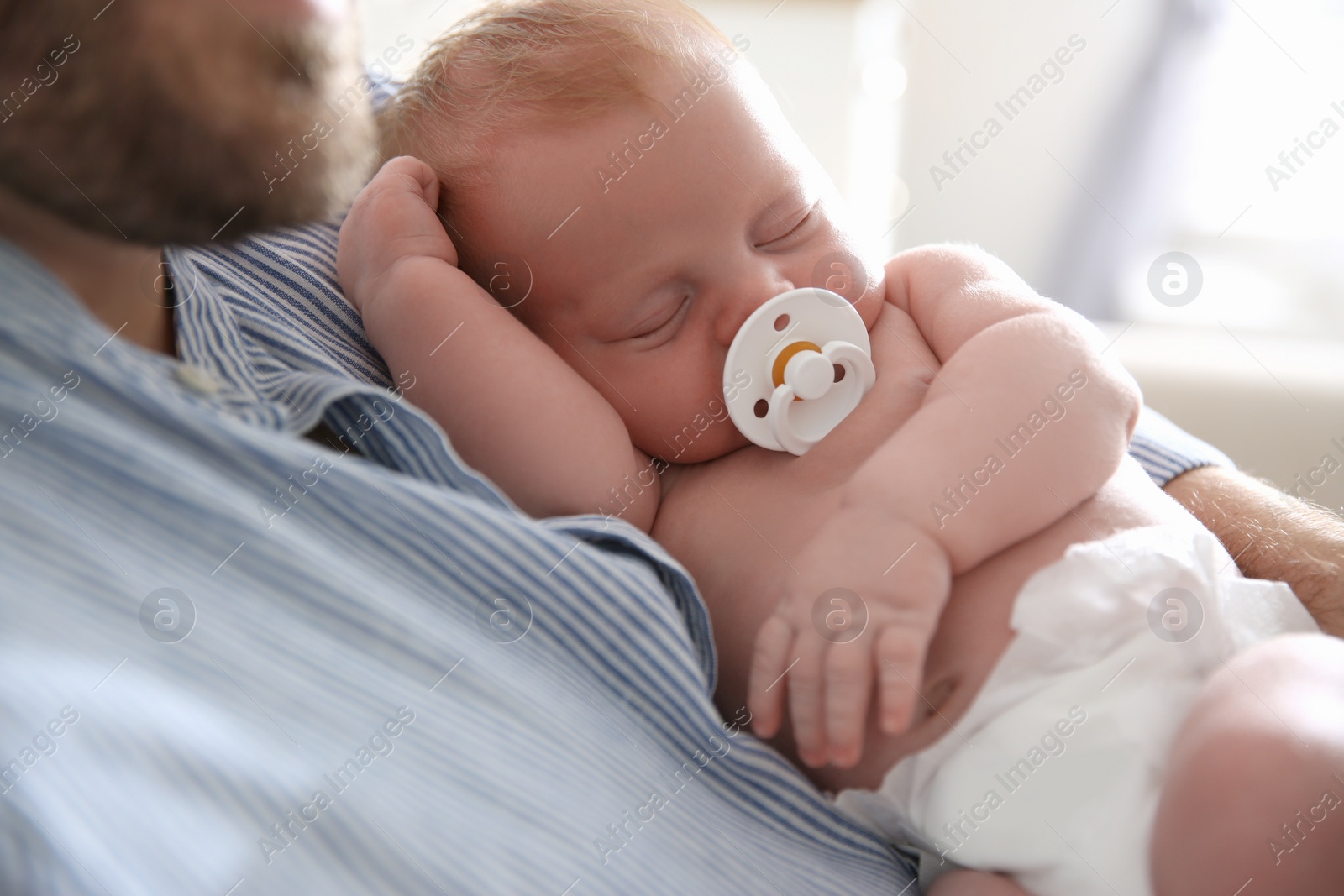 Photo of Father with his newborn son at home, closeup