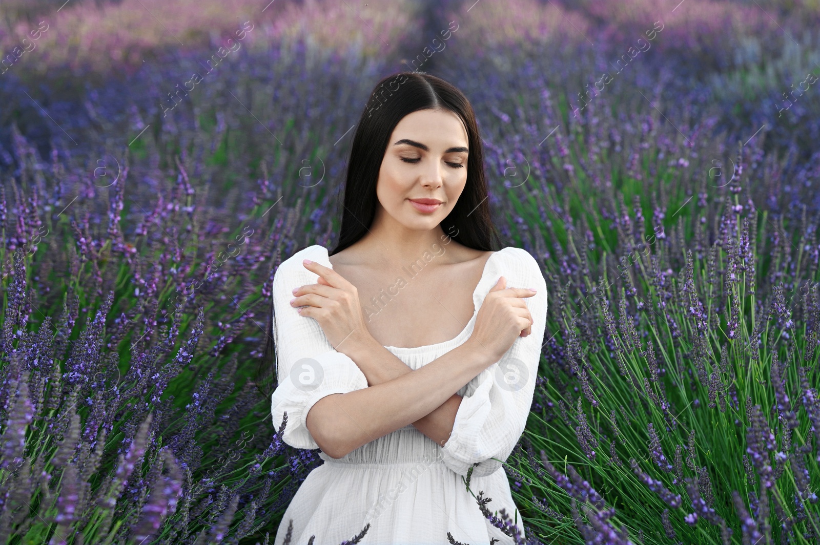 Photo of Portrait of beautiful young woman in lavender field