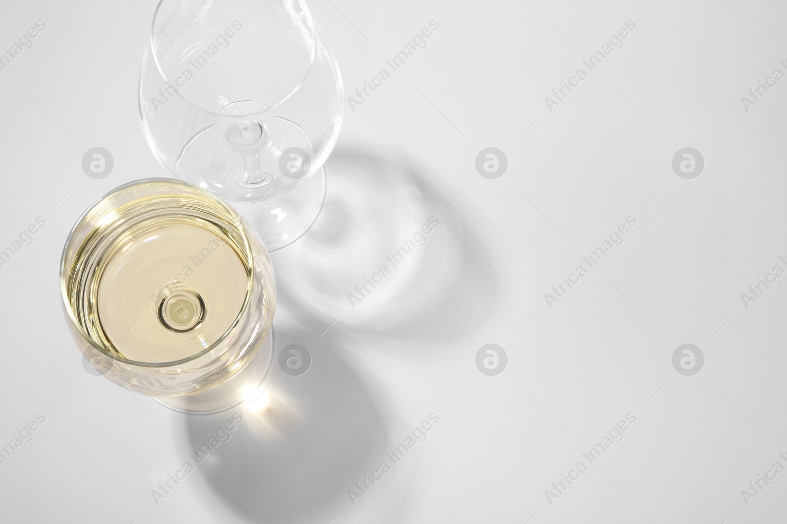 Photo of Tasty aromatic wine in glass isolated on white