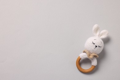 Baby accessory. Rattle on grey background, top view. Space for text
