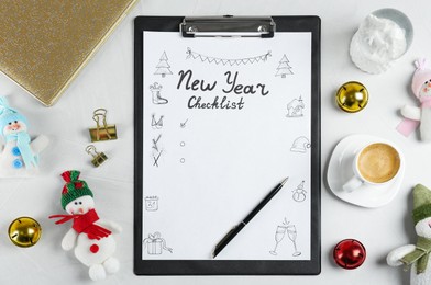 Photo of New Year Checklist. Flat lay composition with clipboard and festive decor on white background