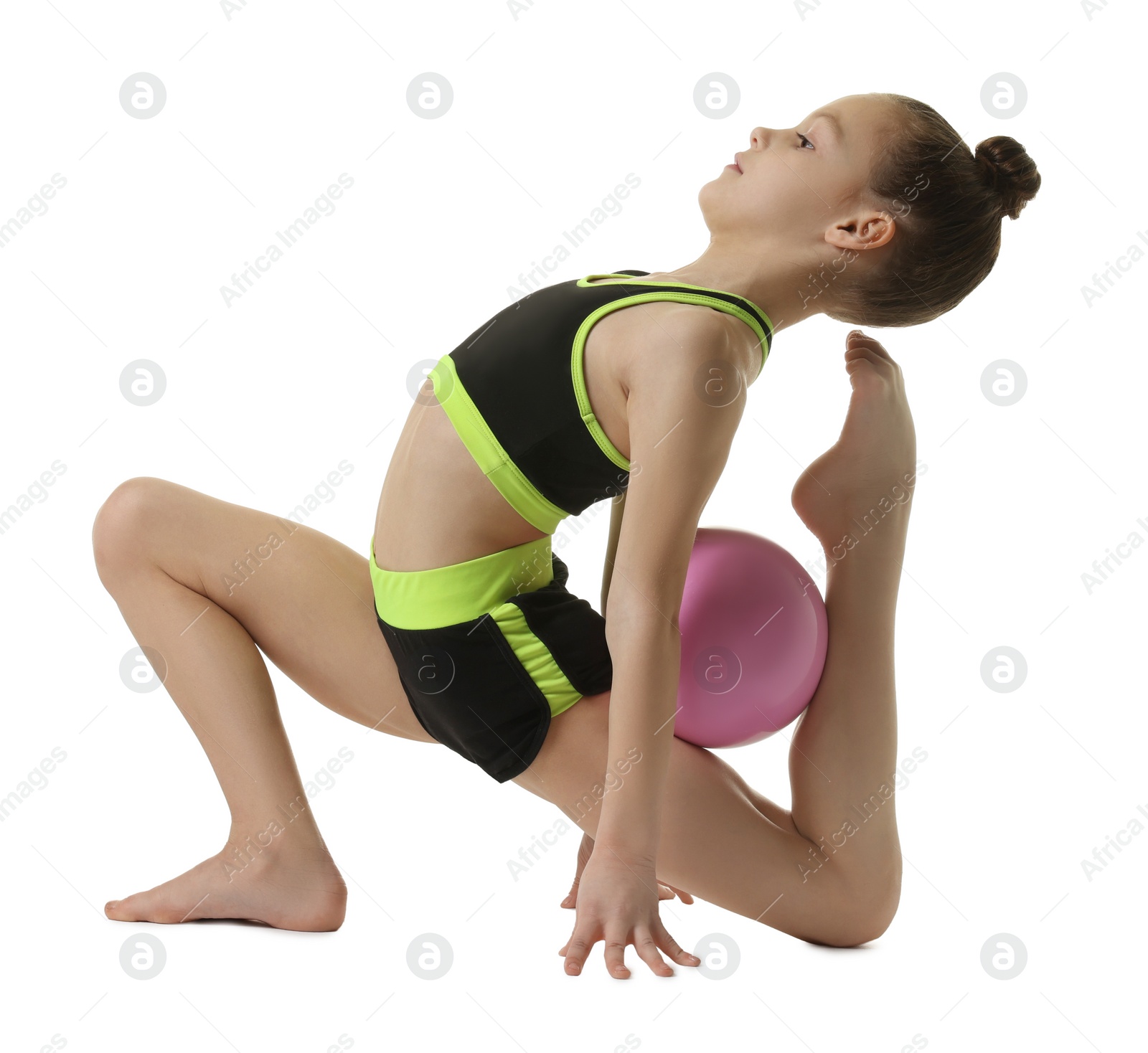 Photo of Cute little girl with ball doing gymnastic exercise on white background