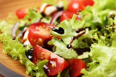 Photo of Fresh vegetable salad with balsamic vinegar, closeup