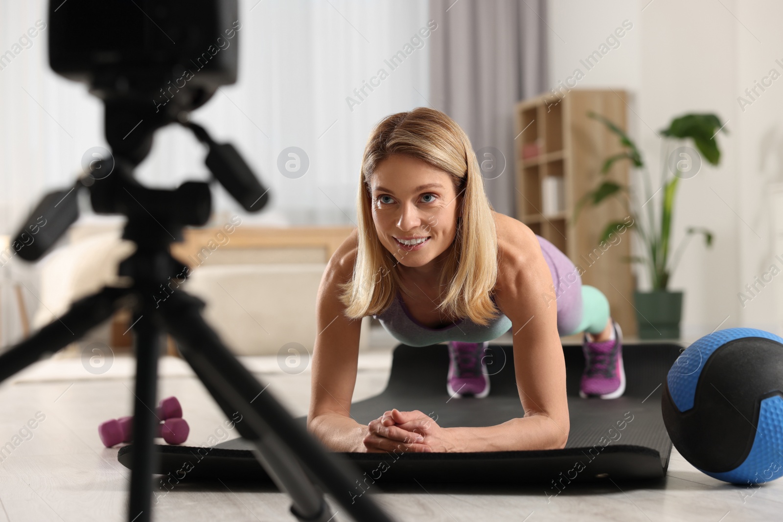 Photo of Fitness trainer recording online classes at home