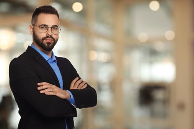 Successful lawyer in glasses on blurred background, space for text