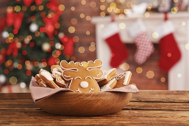 Christmas cookies on wooden table in decorated room 