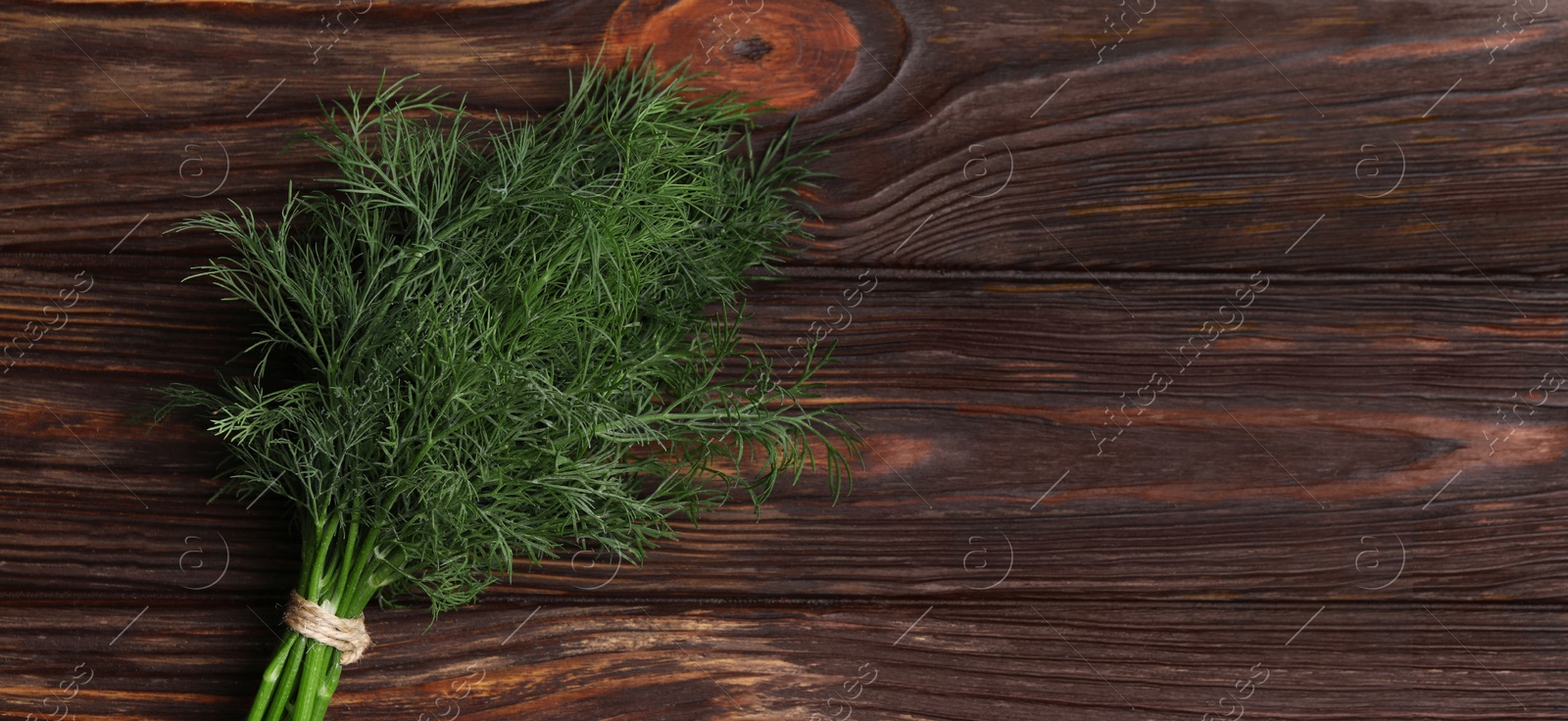 Image of Fresh dill on wooden table, top view. Banner design with space for text