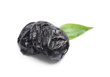 Photo of Tasty prunes and leaf on white background. Dried fruit as healthy snack