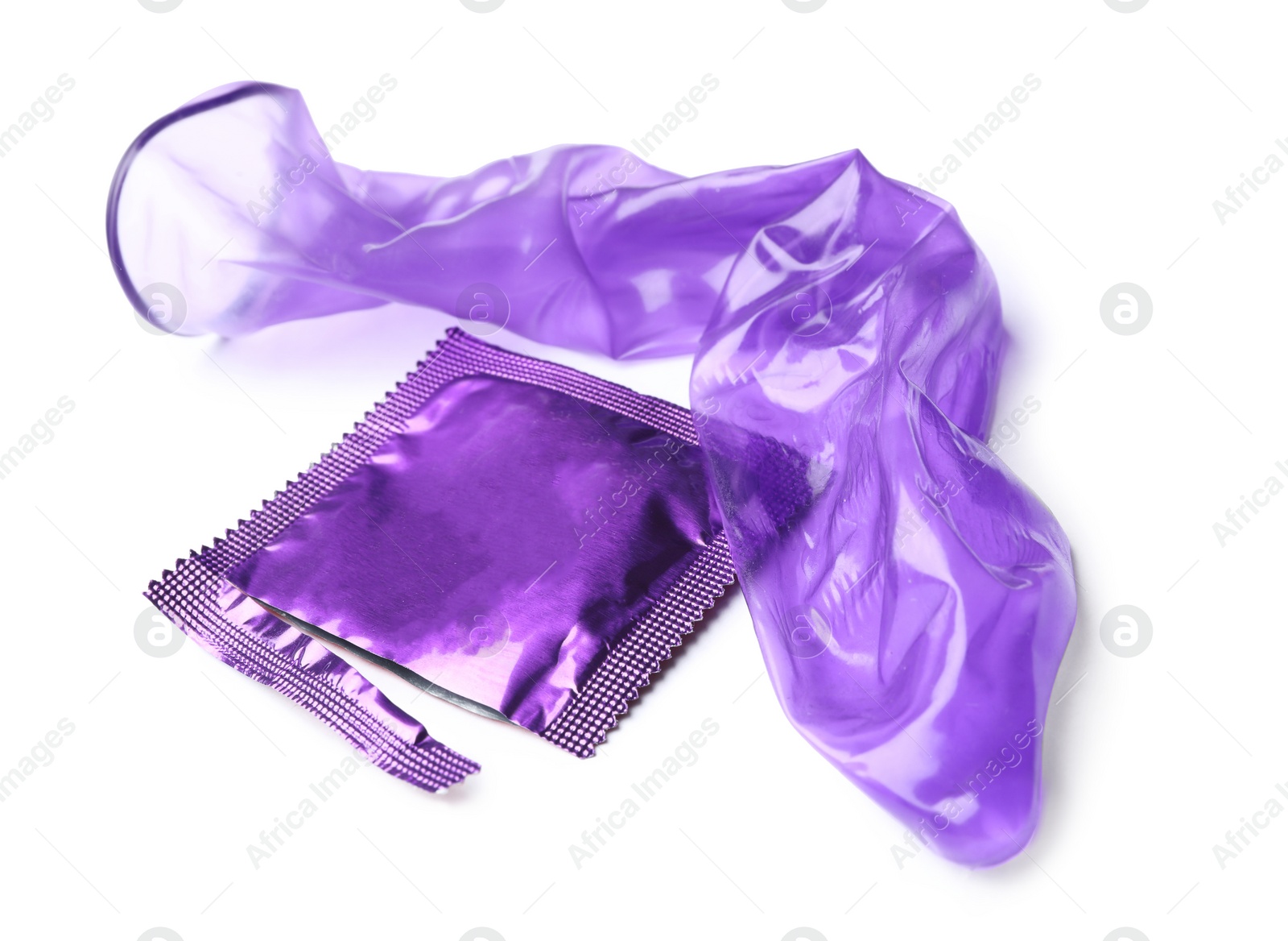 Image of Unrolled violet condom and package on white background. Safe sex