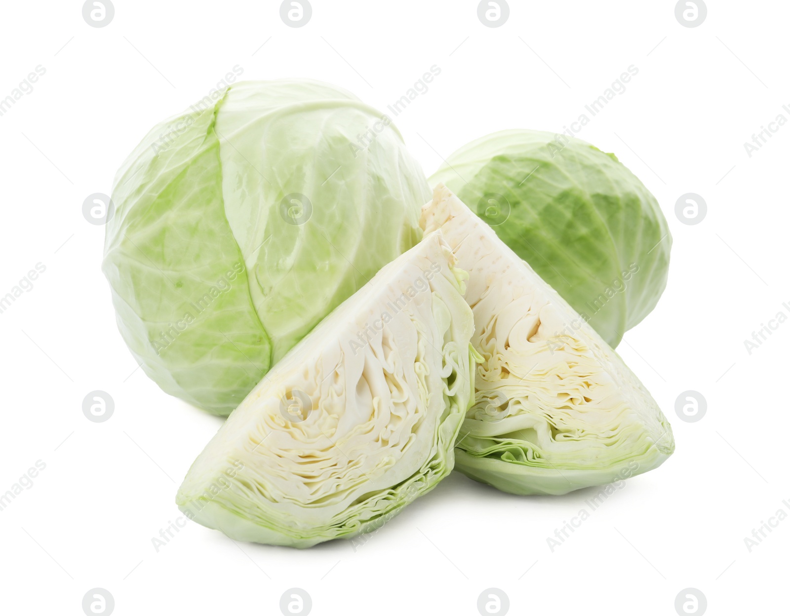 Photo of Whole and cut fresh ripe cabbages on white background