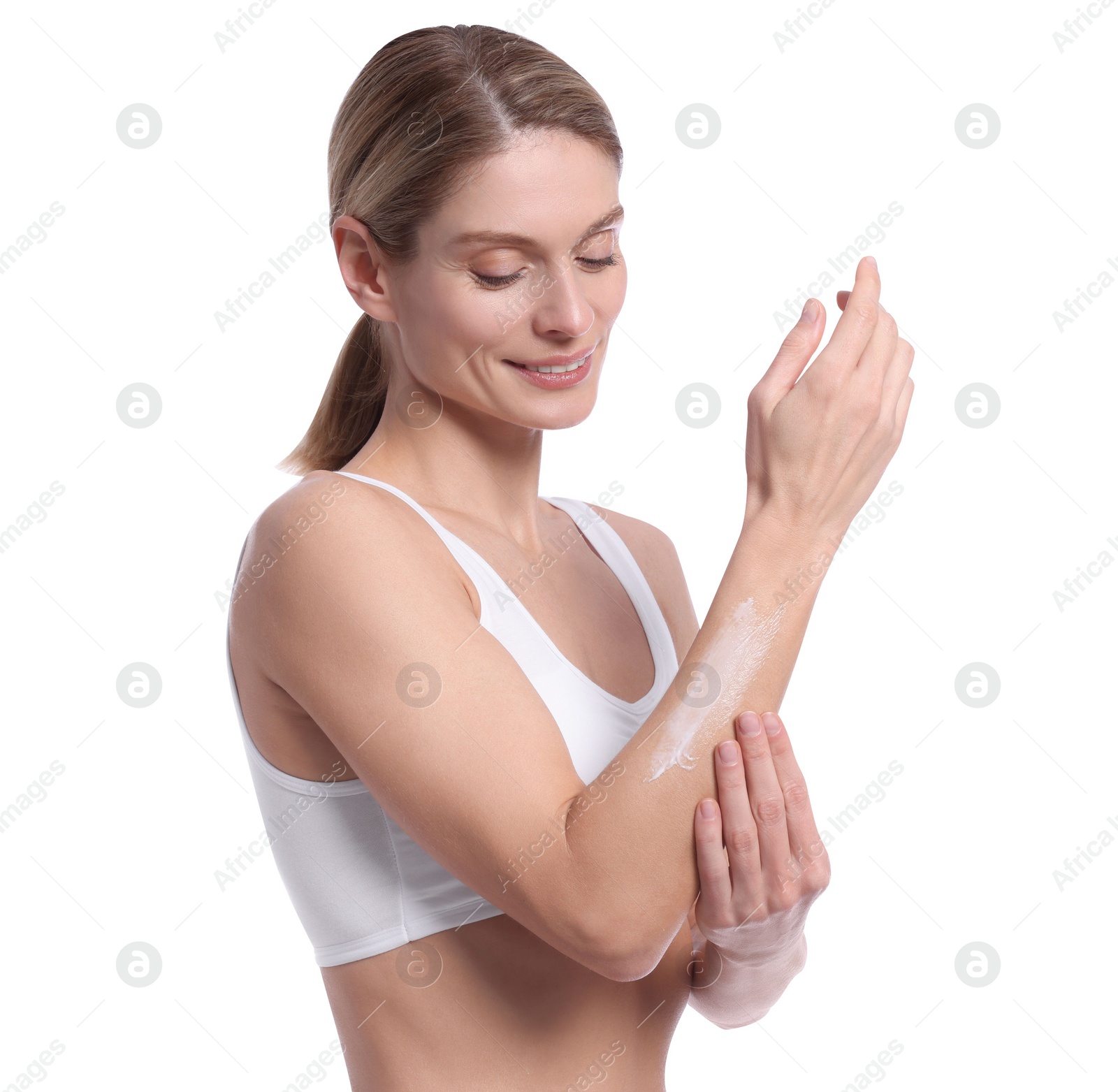 Photo of Woman applying body cream onto her arm against white background