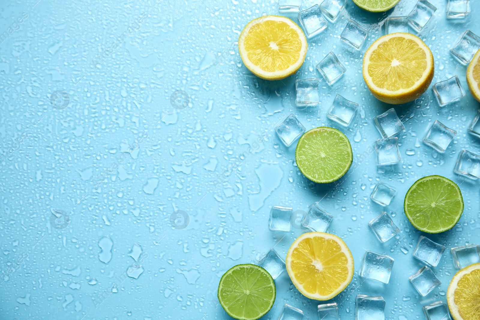 Photo of Ice cubes, cut citrus fruits and space for text on turquoise background, flat lay. Refreshing drink ingredients
