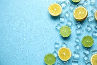 Ice cubes, cut citrus fruits and space for text on turquoise background, flat lay. Refreshing drink ingredients