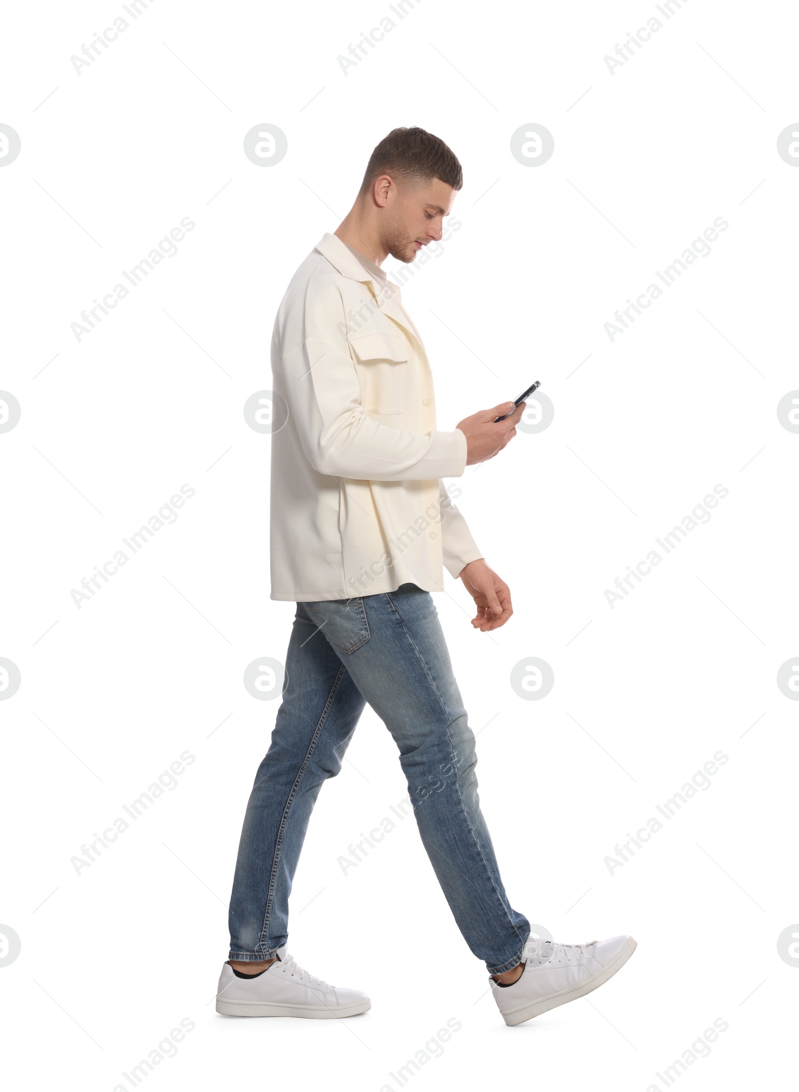 Photo of Man with smartphone walking on white background