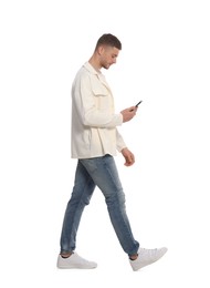 Man with smartphone walking on white background