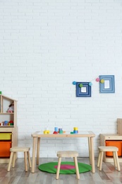 Photo of Modern child room interior with table and stools