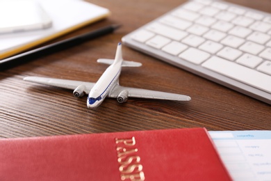 Composition with airplane model on wooden table. Travel agency concept