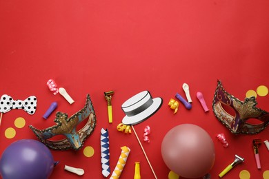 Flat lay composition with carnival items on red background. Space for text
