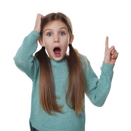 Surprised girl pointing at something on white background