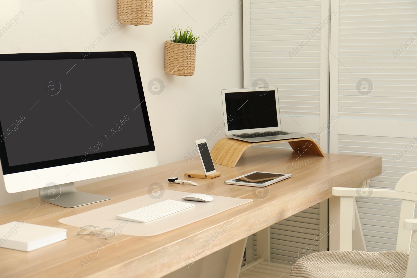 Photo of Stylish workplace interior with modern computer on table. Mockup for design