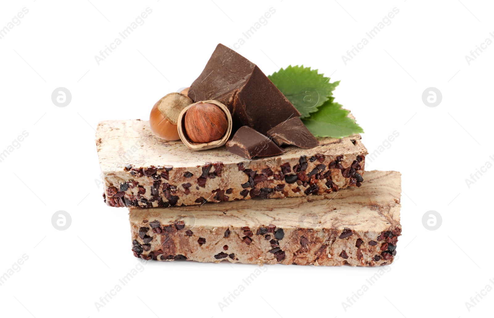 Image of Tasty halva, pieces of chocolate, hazelnuts and green leaves isolated on white