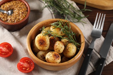 Photo of Delicious grilled potatoes with tarragon and mustard served on table