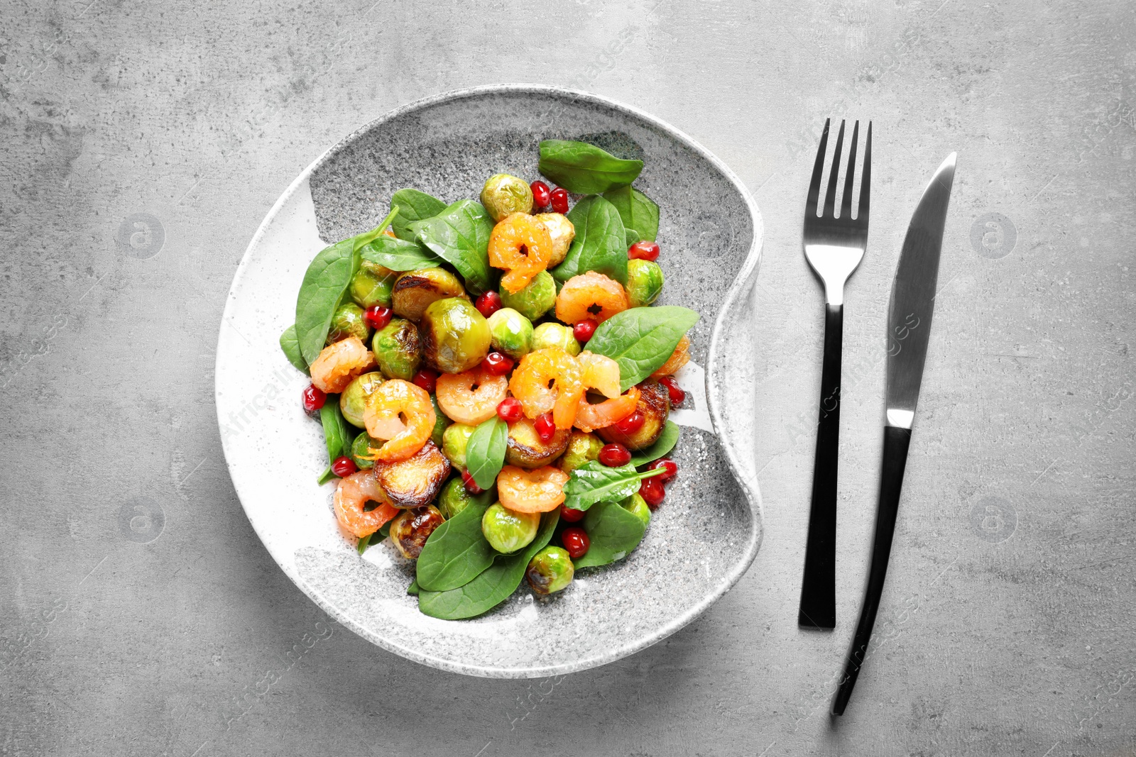 Photo of Composition with warm Brussels sprouts salad on grey table, top view