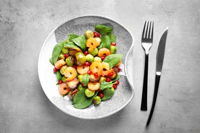 Composition with warm Brussels sprouts salad on grey table, top view