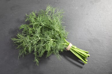 Bunch of fresh dill on grey table, top view