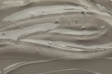 Photo of Clear cosmetic gel on grey background, top view