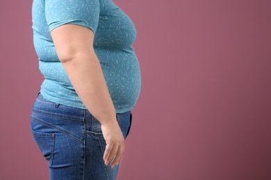 Overweight woman on color background