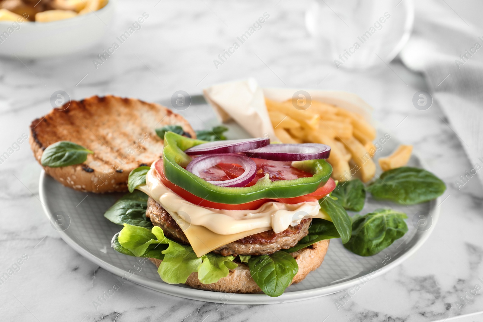 Photo of Plate with tasty burger on marble table