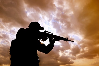 Soldier with machine gun patrolling outdoors. Military service