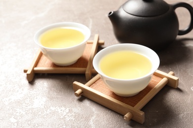 Photo of Cups of Tie Guan Yin oolong tea on table. Space for text