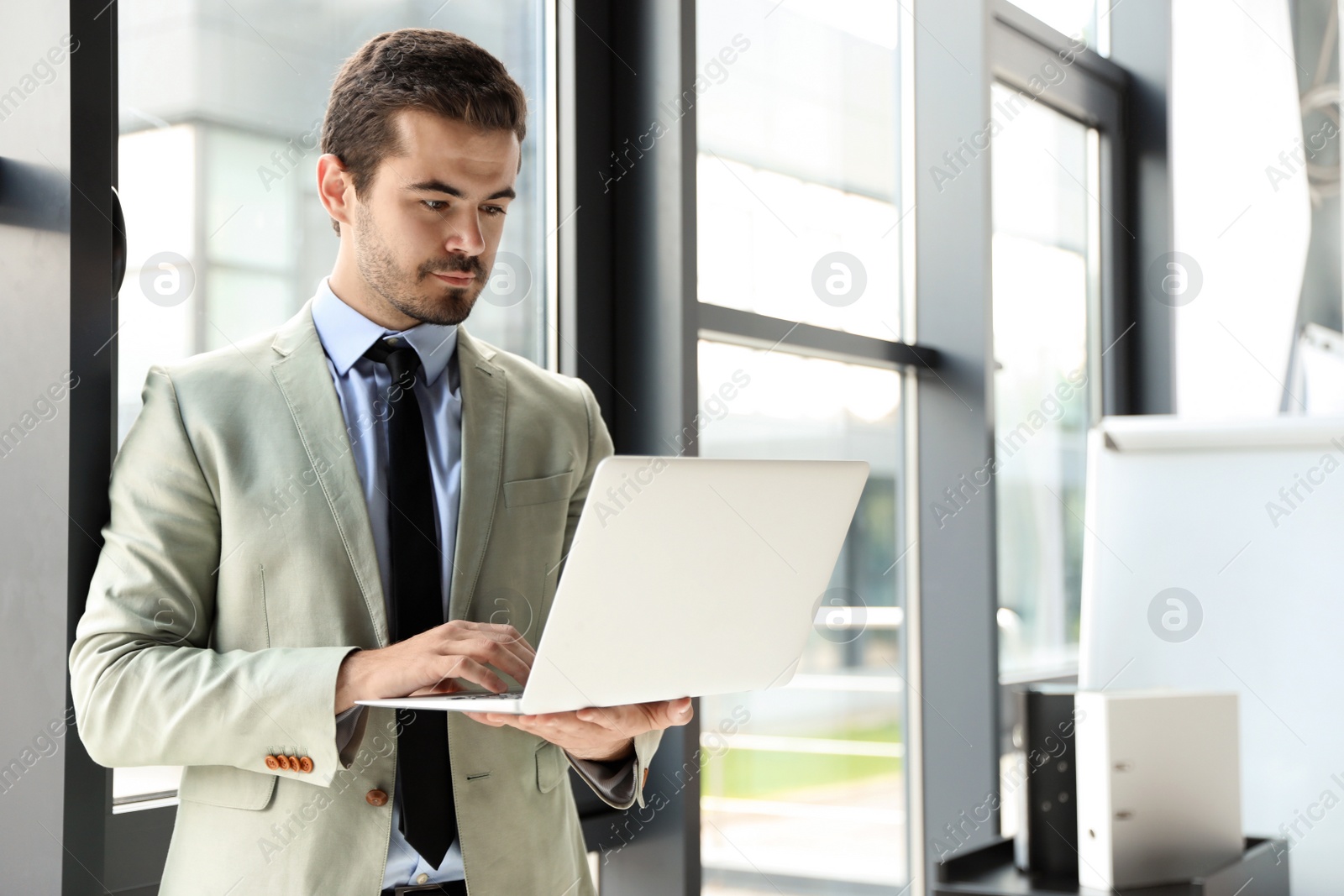 Photo of Male business trainer working with laptop in office