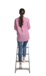 Photo of Young woman climbing up metal ladder on white background, back view