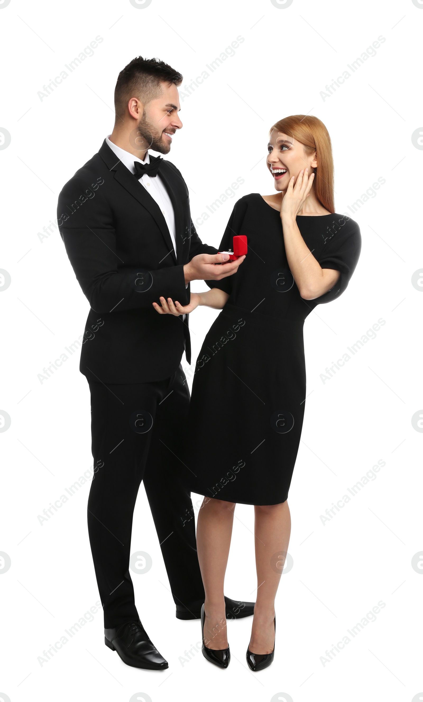 Photo of Man with engagement ring making marriage proposal to girlfriend on white background