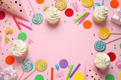 Flat lay composition with cupcakes on pink background, space for text. Birthday party