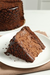 Piece of delicious chocolate truffle cake on table, closeup