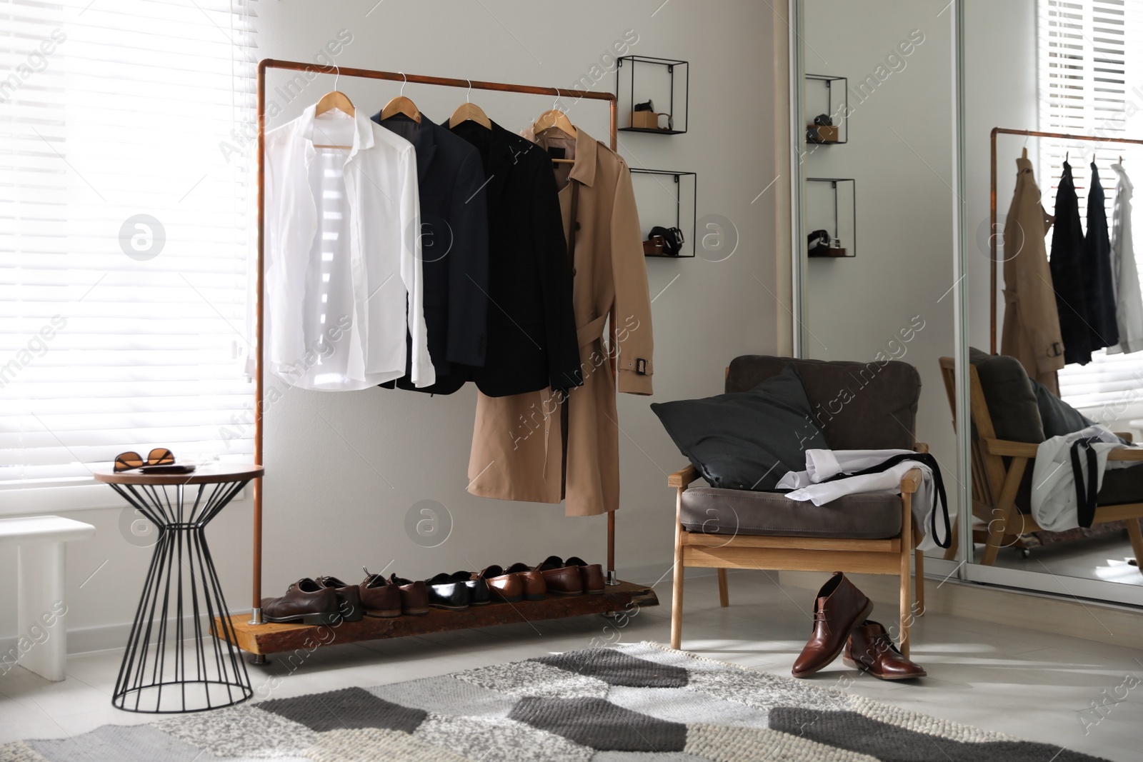 Photo of Dressing room interior with clothing rack and armchair