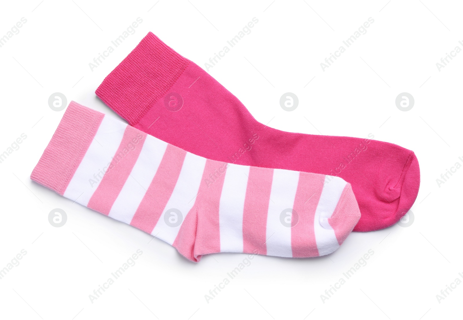 Photo of Different pink socks on white background, top view