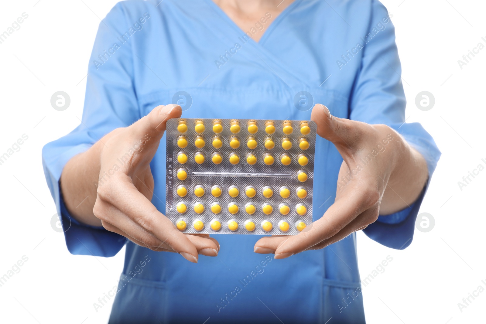 Photo of Female doctor holding pills on white background, closeup. Medical object