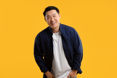 Photo of Portrait of happy man on yellow background