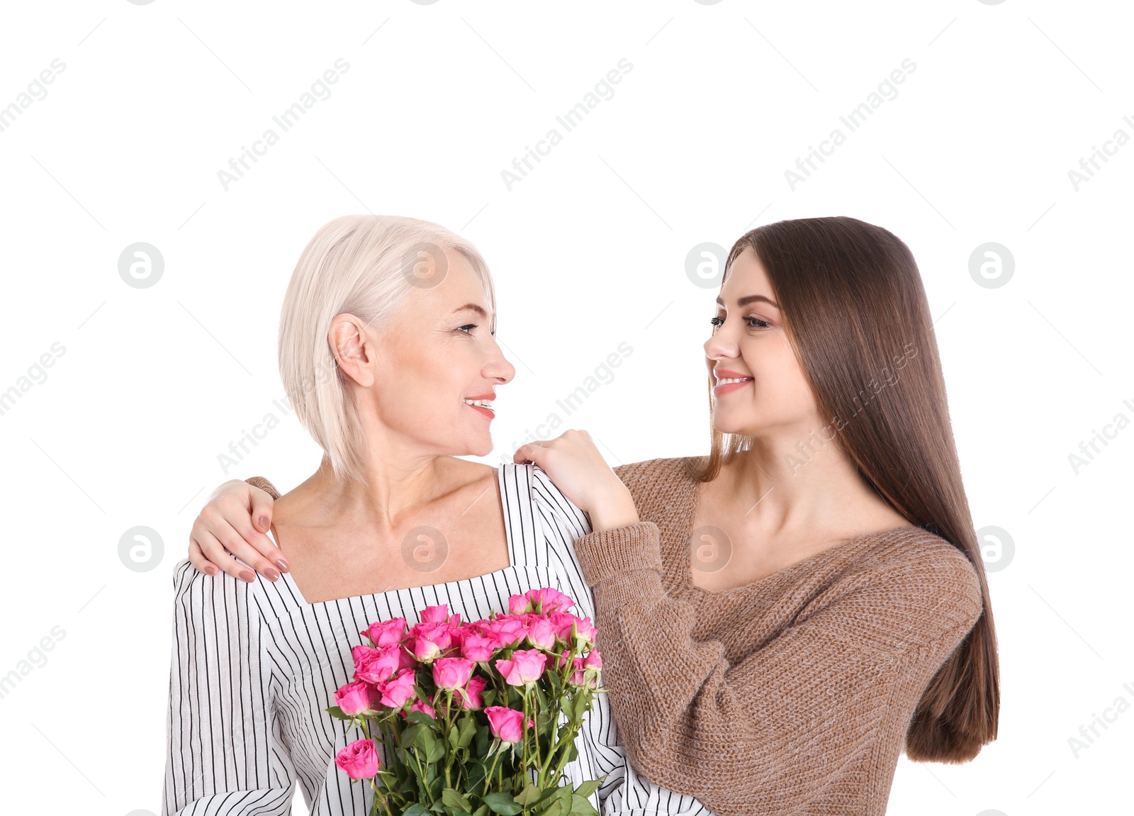 Photo of Young daughter congratulating her mature mother on white background. Happy Women's Day
