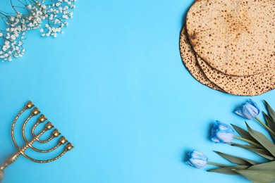 Photo of Flat lay composition with matzos on light blue background, space for text. Passover (Pesach) celebration