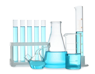 Different laboratory glassware with light blue liquid isolated on white